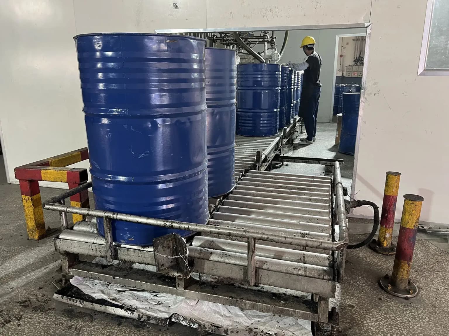 Automated filling line packaging finished composite resin into barrels.