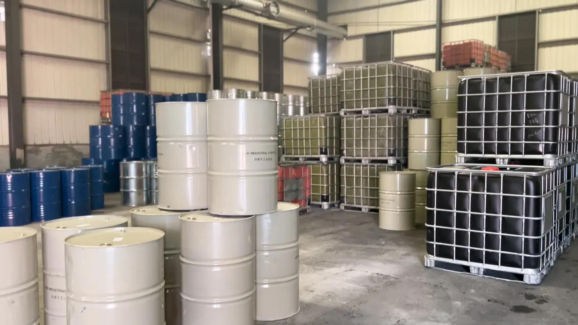 Spacious and organized warehouse at Changyuan New Materials with stacked barrels of resin.